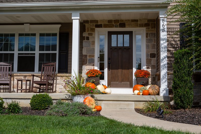 The Signature Porch shot straight on with its rocking chairs, a pumpkin engraved The Morgans among the display