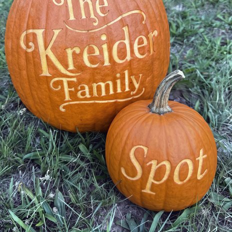 An engraved field tripper with one first name on it, beside a full-size carver for scale