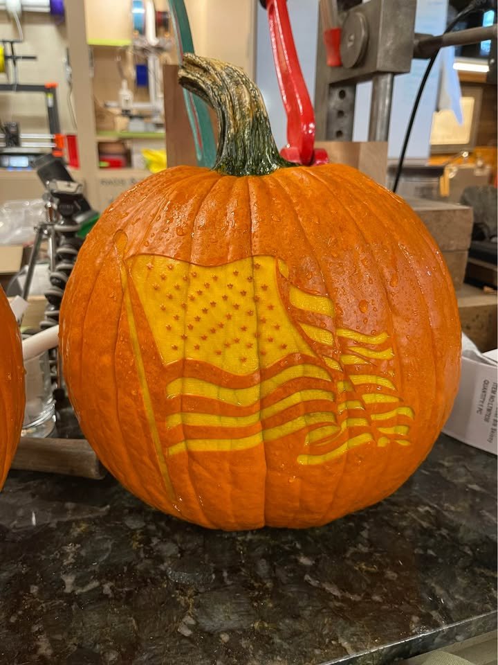 A pumpkin laser-engraved with a detailed American flag