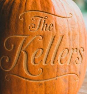A close crop of the flowing script style, engraved on a pumpkin